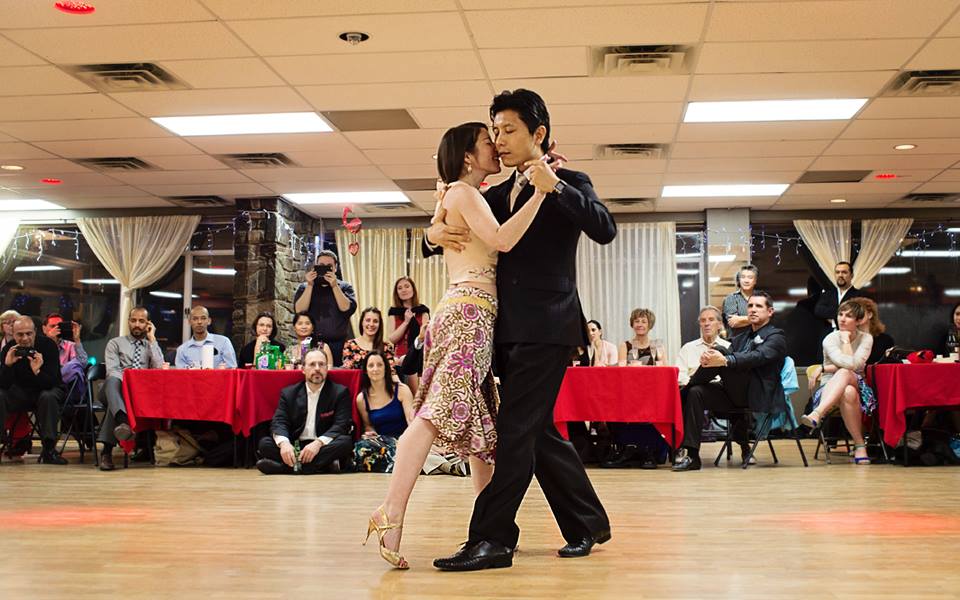 Rick Kim and his partner dancing in an embrace